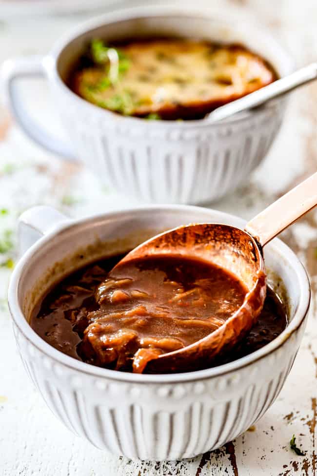 ladling traditional French Onion Soup into a bowl