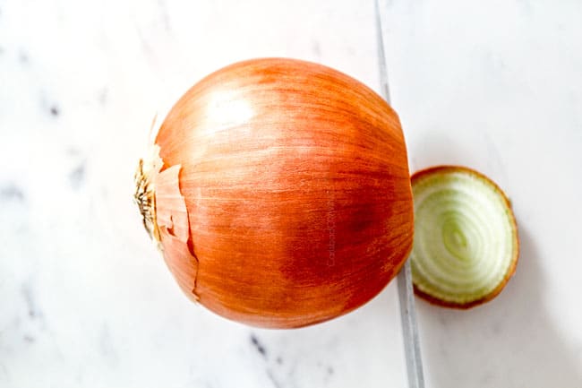showing how to cut onions for French Onion Soup by cutting the ends off