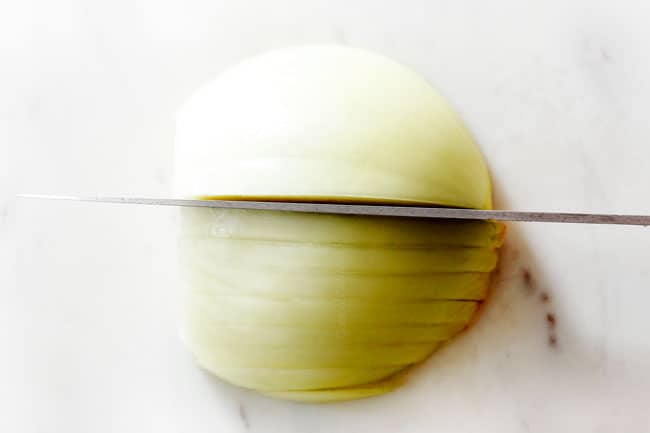 showing how to cut onions for French Onion Soup by slicing them into even 1/4" slices