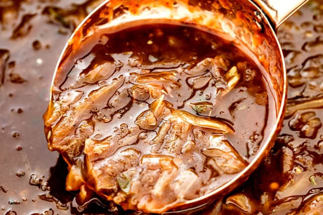 showing up close of a ladle full of easy French Onion Soup after simmering