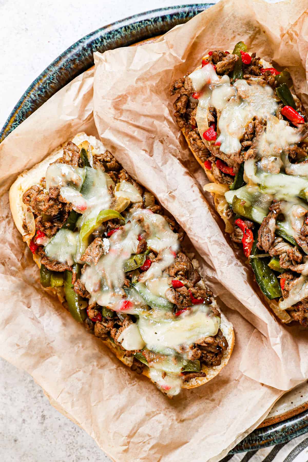 open face Philly cheesesteak recipe on a plate showing the cheesy, meaty filling