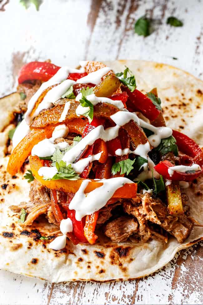 showing how to make pork fajitas by adding pork bell peppers and sour cream to a tortilla