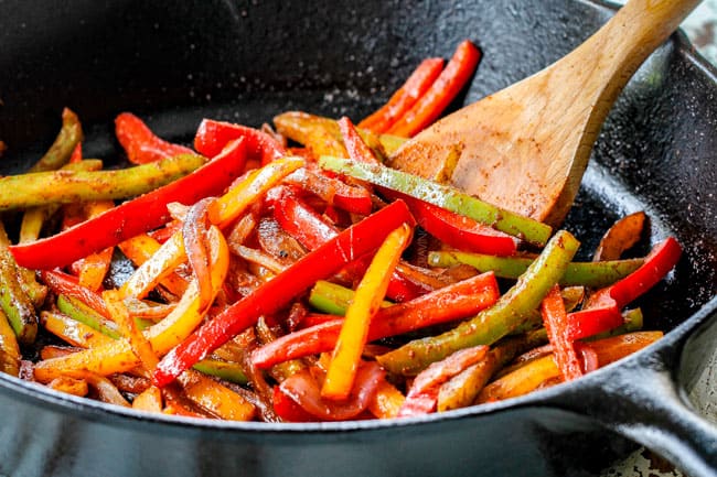showing how to make pork fajitas by stir frying red, yellow and green bell peppers