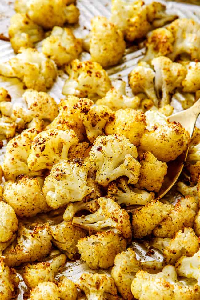 a spoonful of Parmesan roasted cauliflower on a baking sheet