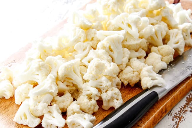 showing how to make roasted cauliflower by chopping cauliflower