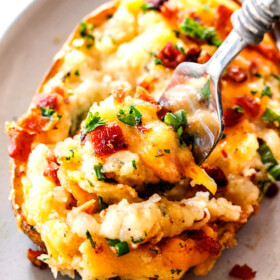 a fork taking a bite out of best twice baked potatoes