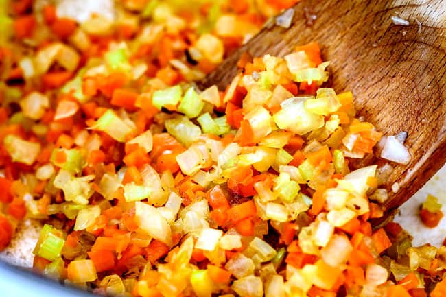 showing how to make marinara sauce by cooking onions, celery and carrots