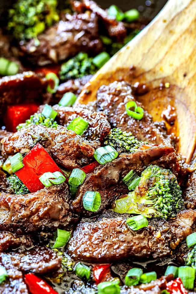 showing how to make Mongolian beef by stirring beef , broccoli and bell peppers together in a skillet