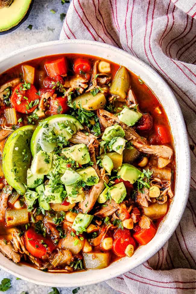 top view of easy Caldo de pollo with cabbge (Mexican Chicken Soup) in a white bowl