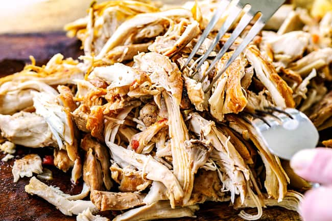 showing how to make African Peanut Stew by shredding chicken