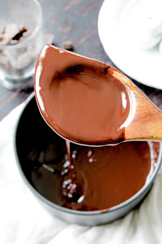 5 Minute Fool Proof Chocolate Ganache (sauce) is silky, creamy, sweet and 1,000 TIMES BETTER than any store bought chocolate sauce. Perfect for brownies, ice cream, cakes, popcorn, strawberries, etc a wooden spoon full of chocolate ganache