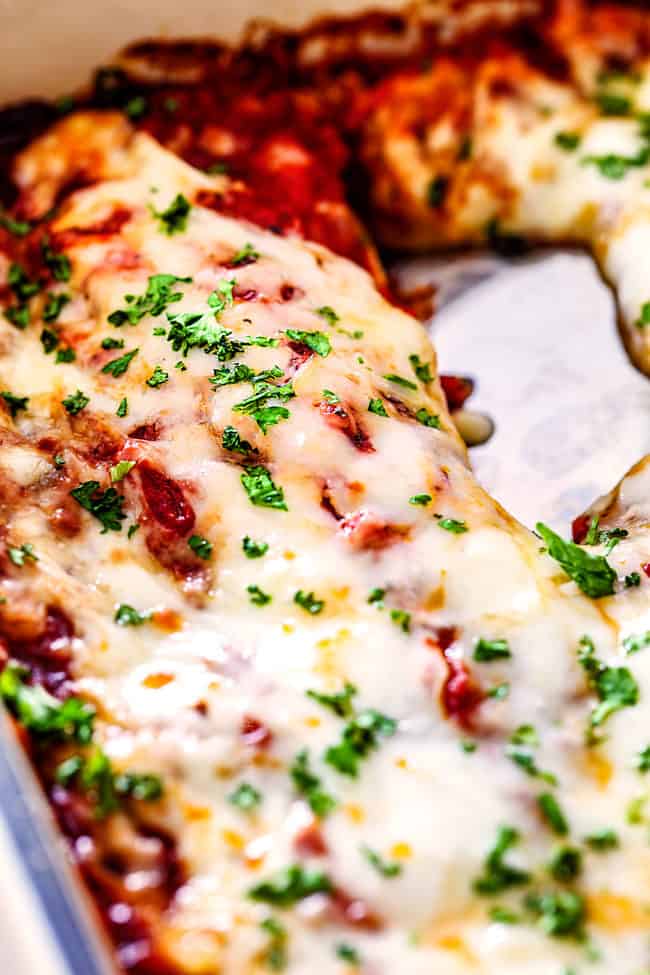 a spatula digging into a casserole dish of best manicotti