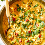 up close top view of creamy coconut curry chicken in a stainless steal skillet