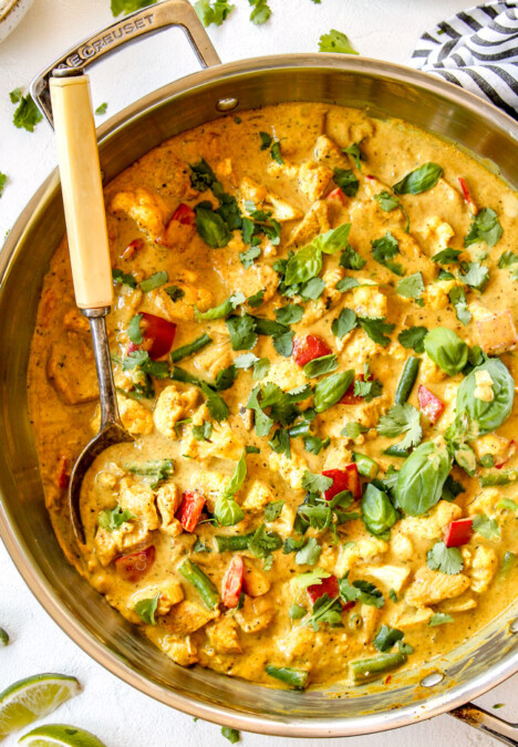 up close top view of creamy coconut curry chicken in a stainless steal skillet