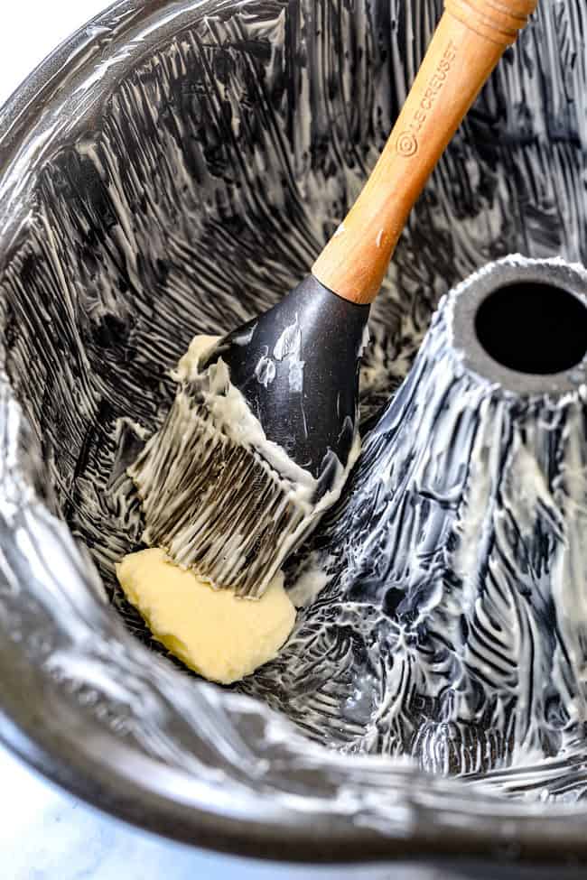 showing how to make Kentucky Butter Cake by buttering a bundt pan