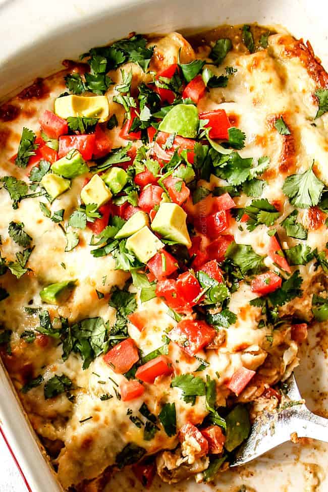 top view of half eaten enchiladas verdes suzias with a spatula