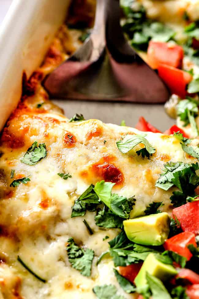 up close of a spatula digging into cheese enchiladas verdes