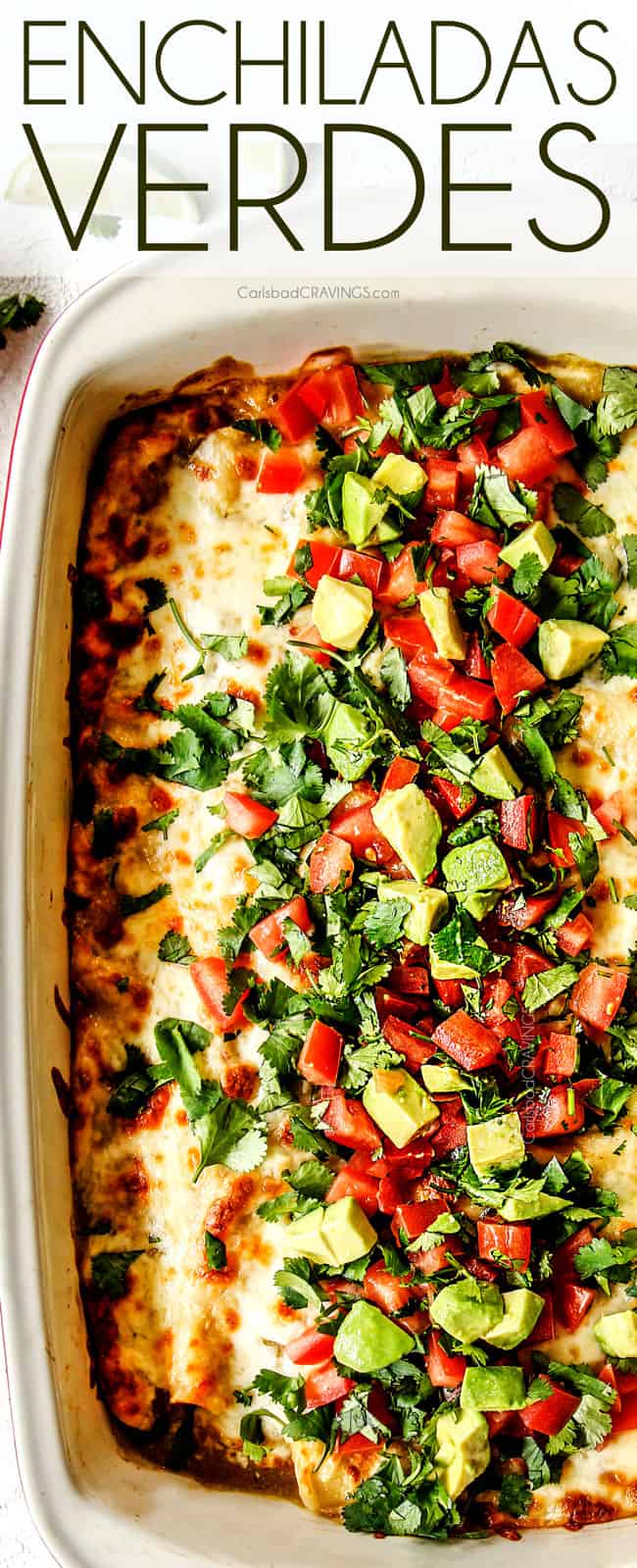 top view of enchiladas verdes casserole topped with cheese, cilantro, tomatoes, avocados