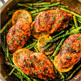 top view of lemon pepper chicken and asparagus in a skillet