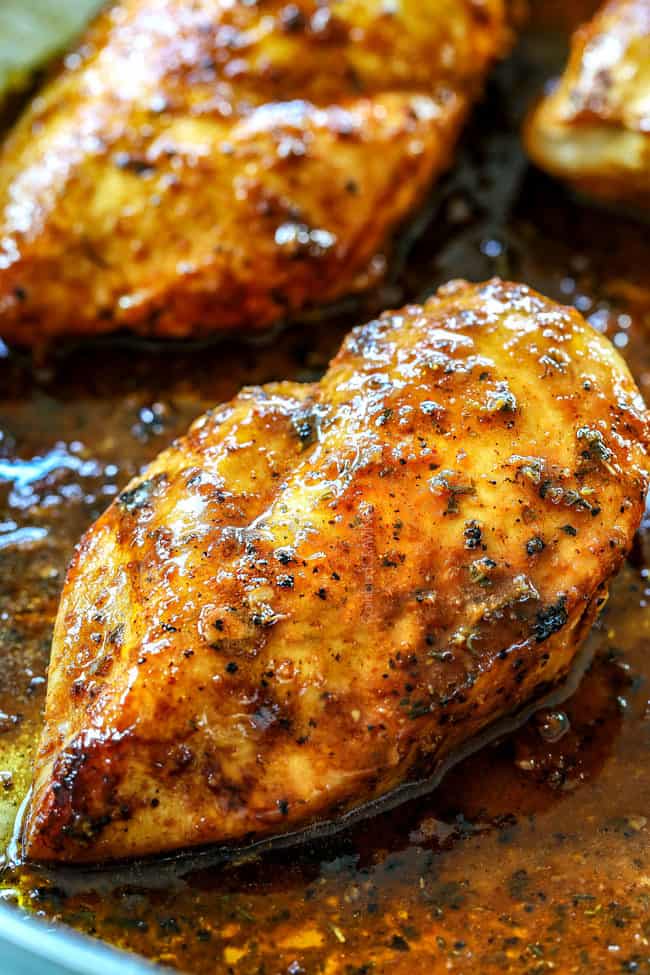 showing how to make lemon pepper chicken by cooking chicken in a skillet until golden