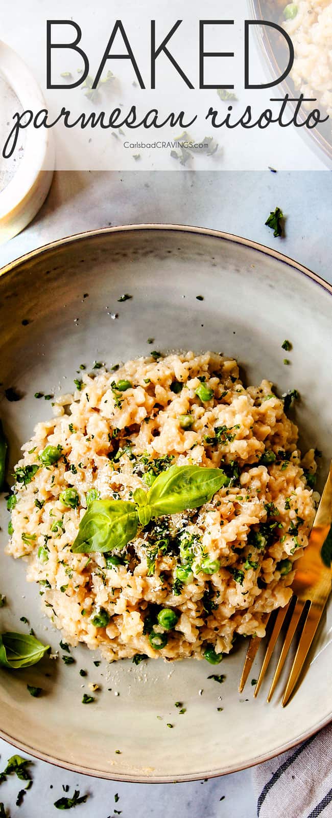 top view of Parmesan risotto recipe in a grey dish garnished with basil and parsley