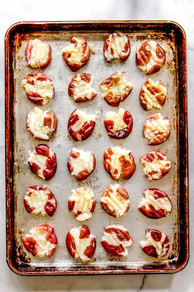 showing how to make smashed potatoes with a top view of smashed potatoes on a baking sheet