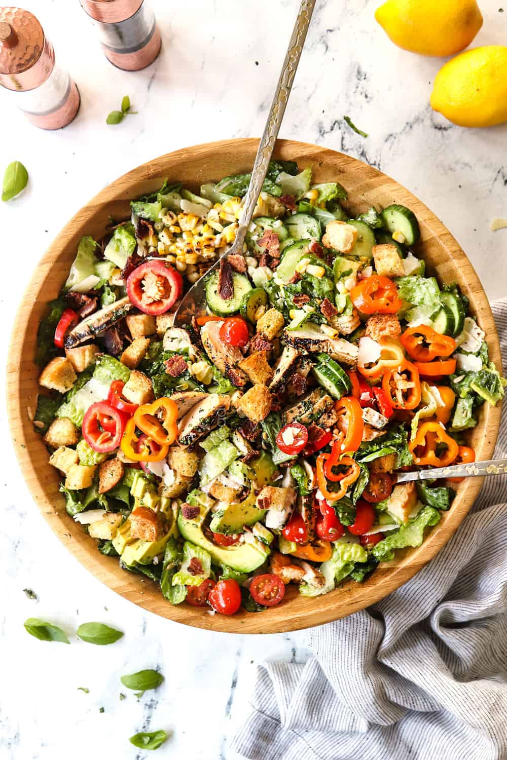 top view of tossed Chicken Caesar Salad with grilled lemon basil chicken