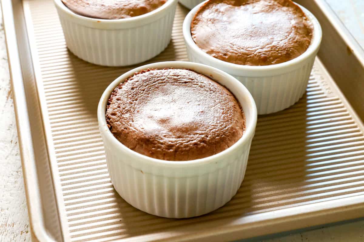 showing how to make chocolate lava cake recipe by baking until the edges are set and the center is jiggly