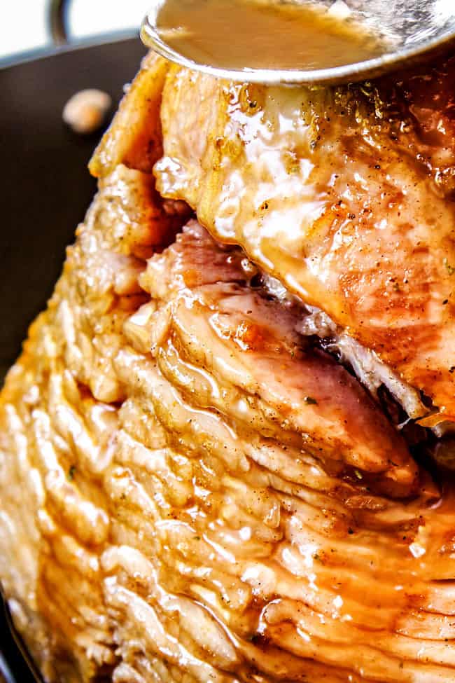 showing how to make honey baked ham by basting with juices