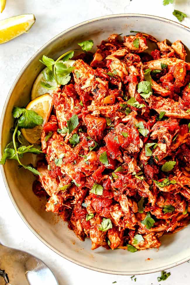 up close of Mexican Shredded Chicken in a white bowl for tacos
