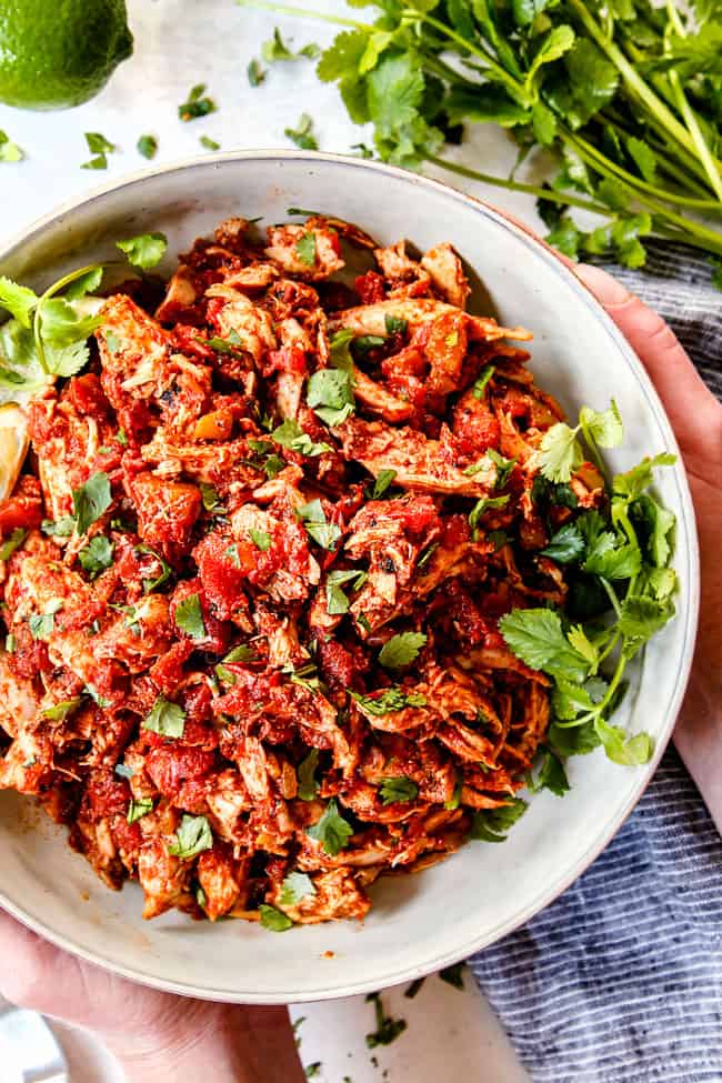 up close of Mexican Shredded Chicken in a white bowl for tacos