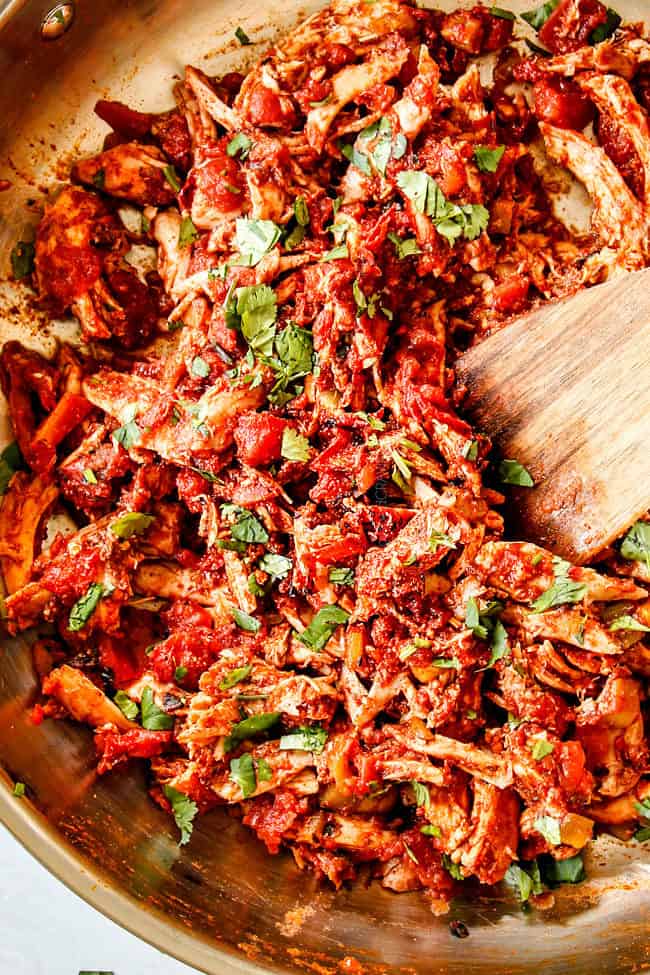 up close of top view of easy Mexican Chicken in a skillet garnished by cilantro