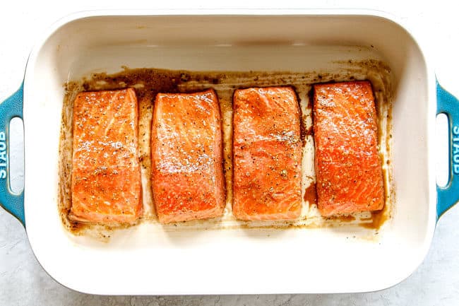showing how to bake salmon in the oven by lining salmon fillets in a 9x13 baking dish