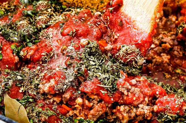 showing how to make authentic bolognese sauce by adding parsley, thyme, oregano, basil, crushed tomatoes to a pot