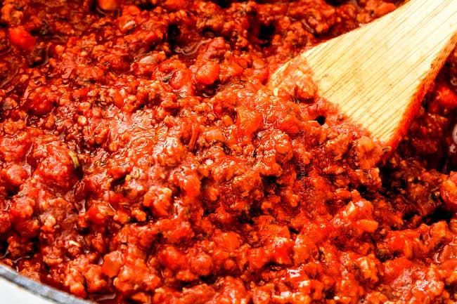 showing how to make the authentic bolognese sauce by simmering until thick