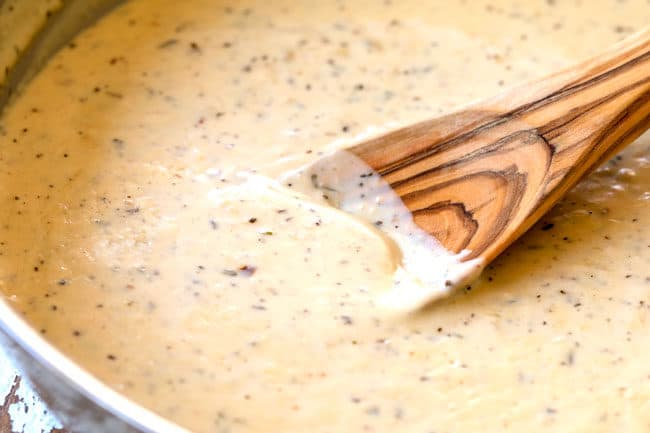 showing how to make Chicken Alfredo Bake by melting Parmesan in Alfredo Sauce
