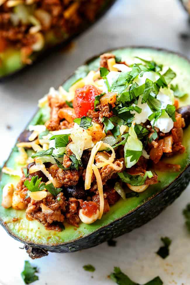 healthy stuffed avocados recipe on a white plate