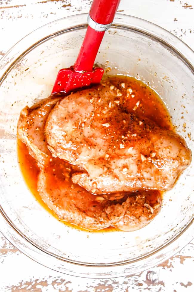 showing how to make chicken gyro recipe by adding chicken to Greek marinade