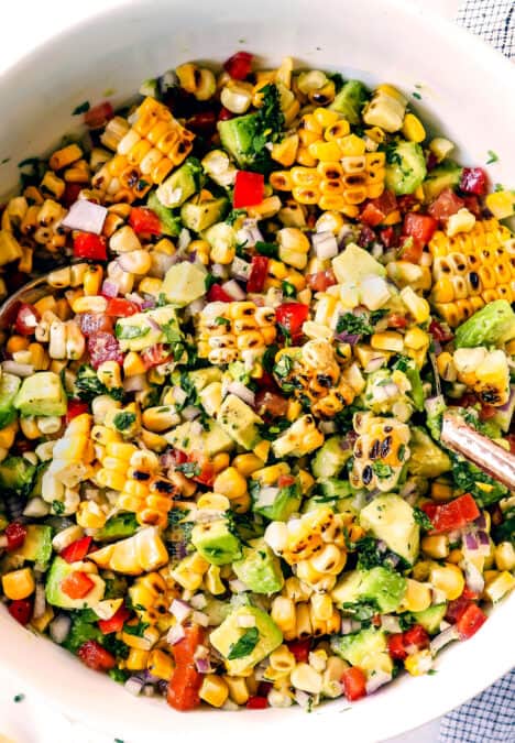 top view of a tossing avocado corn tomato salsa