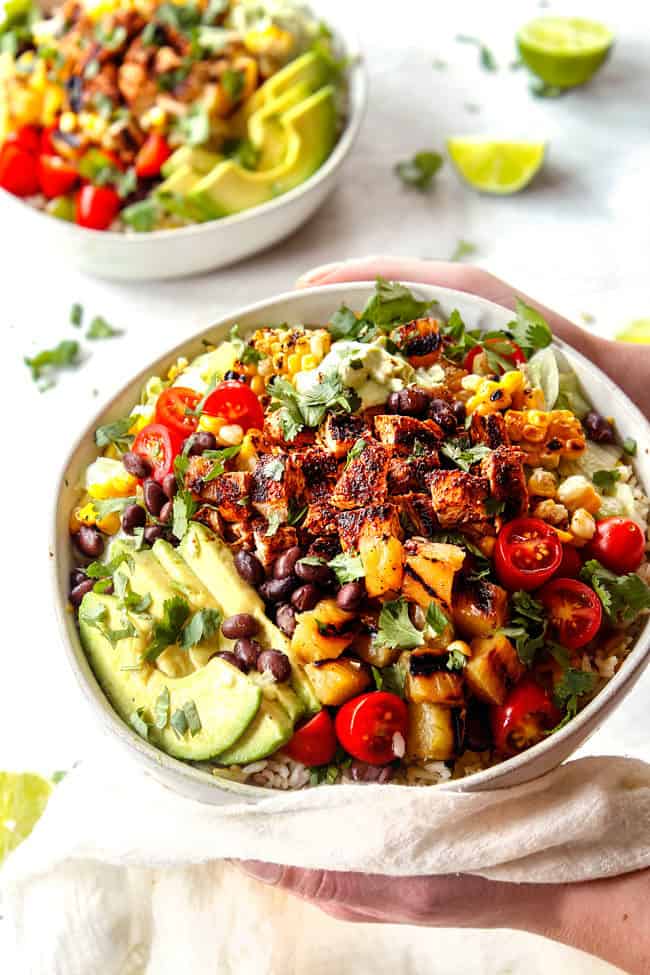 two hands holding chipotle burrito bowl