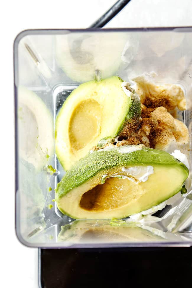 showing how to make salmon bowls by adding avocados, sour cream, lime juice, garlic to blender