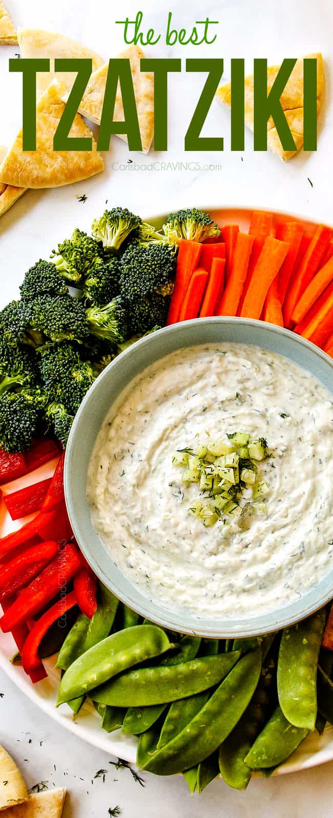 top view of Tzatziki in a bowl surrounded by vegetables showing how to serve Tzatziki