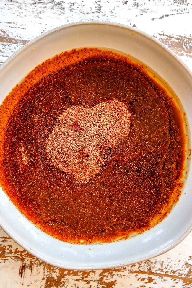 showing how to make carne asada tacos by adding olive oil to spices tot create a wet rub