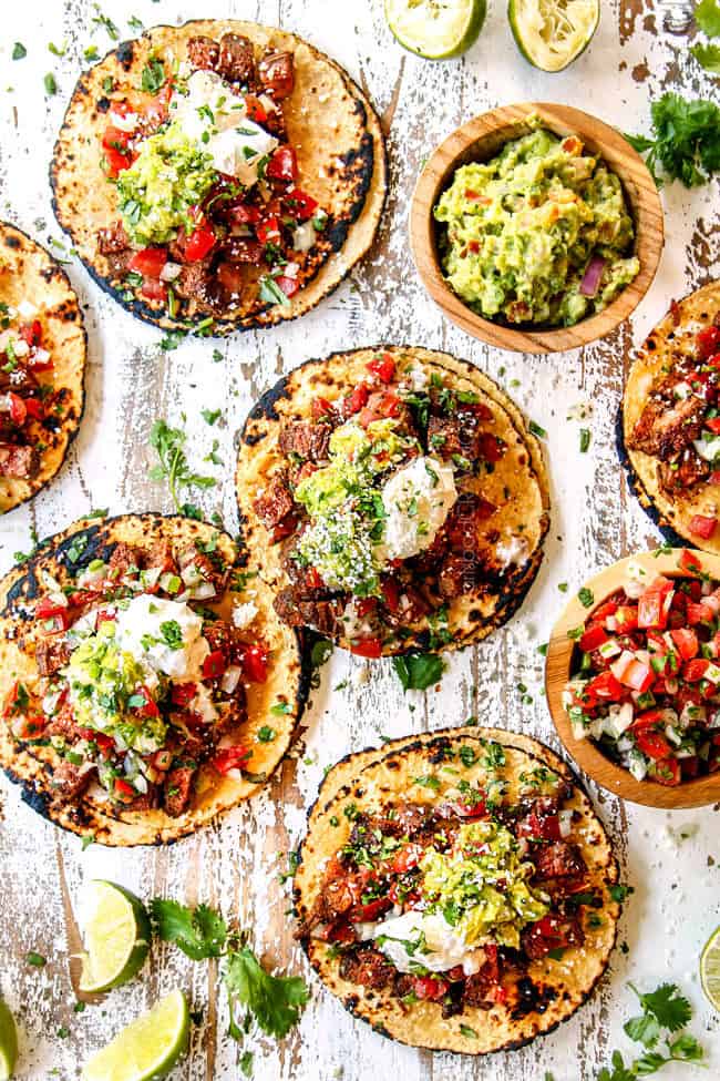 top view of street tacos recipe with carne asada, guacamole, sour cream, pico de gallo