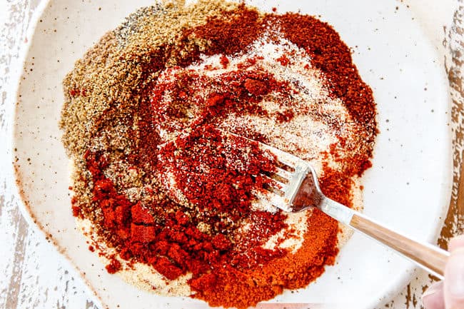 showing how to make street tacos by whisking seasonings together