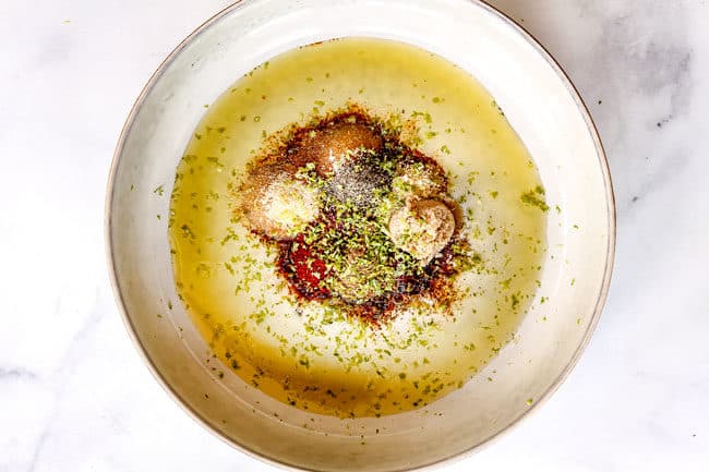 showing how to make fiesta lime chicken by adding olive oil, lime juice, lime zest, chili powder, cumin, garlic powder, onion powder, etc to a bowl