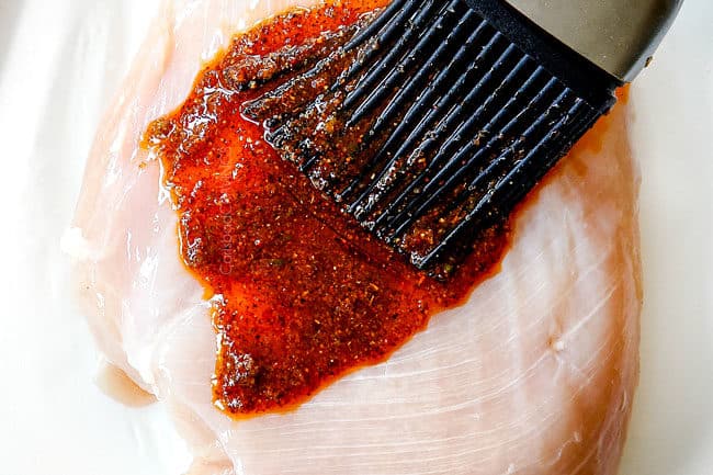 showing how to make fiesta lime chicken by adding wet rub to chicken