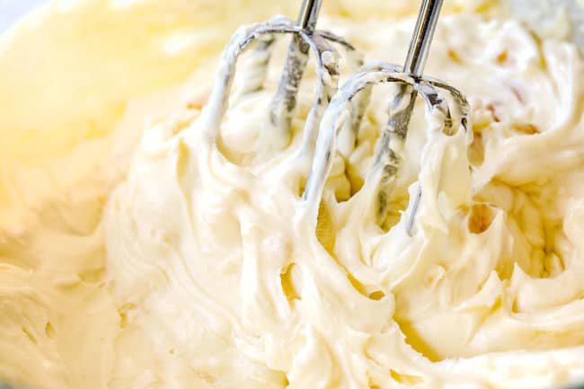 showing how to make hummingbird cake by beating cream cheese frosting