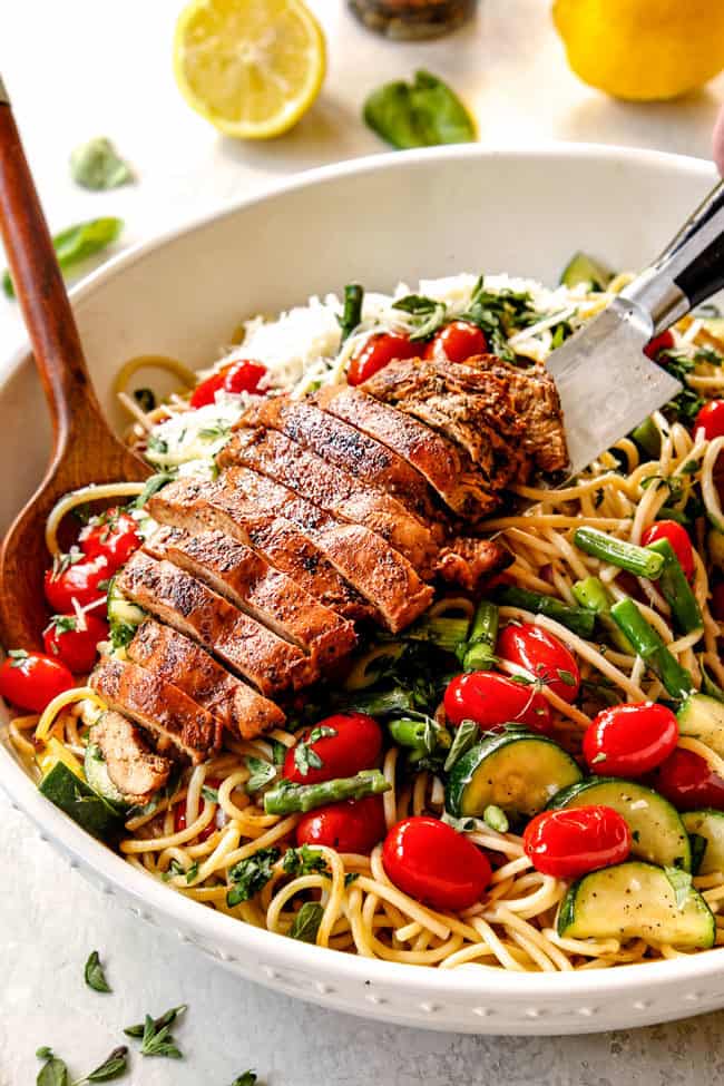 showing how to make lemon chicken pasta by adding lemon chicken to pasta