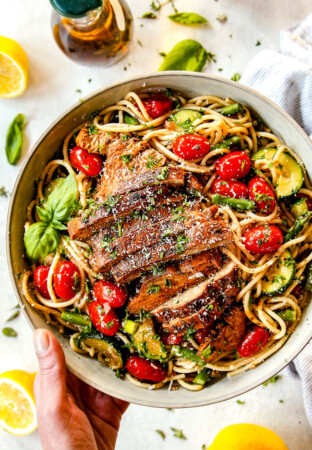 top view of lemon chicken pasta with asparagus in a white bowl